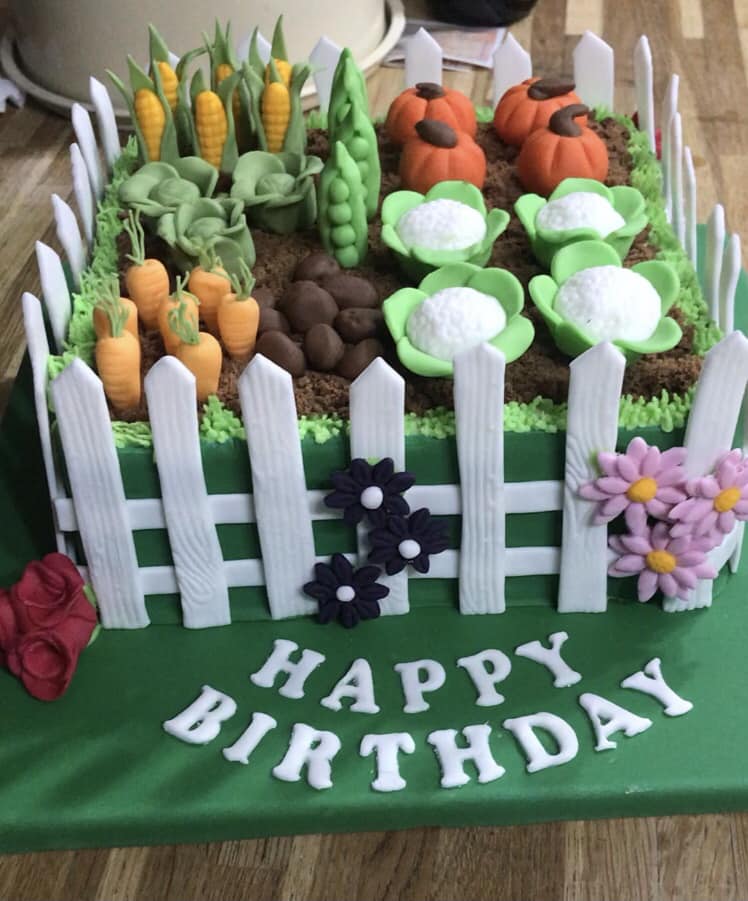 allotment design cake made in kent with white picket fence