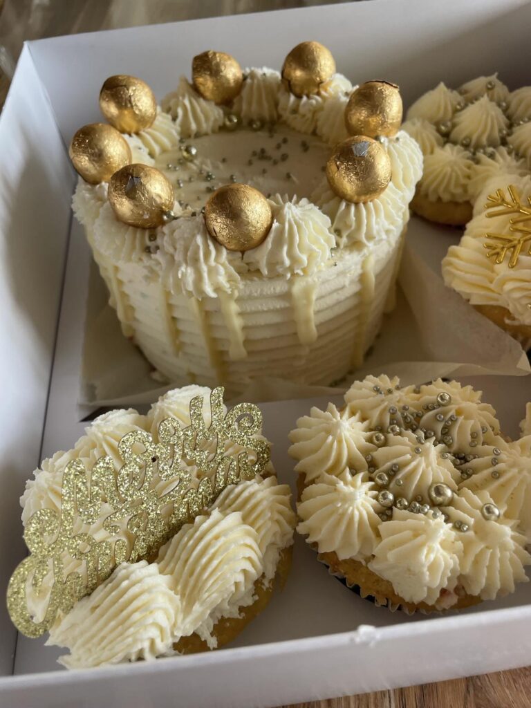custom made gold cake with ruffle icing and gold balls in a circle