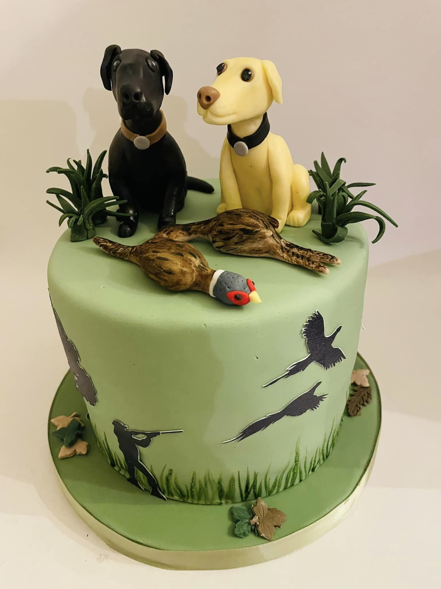 shooting themed birthday cake with two labradors on top
