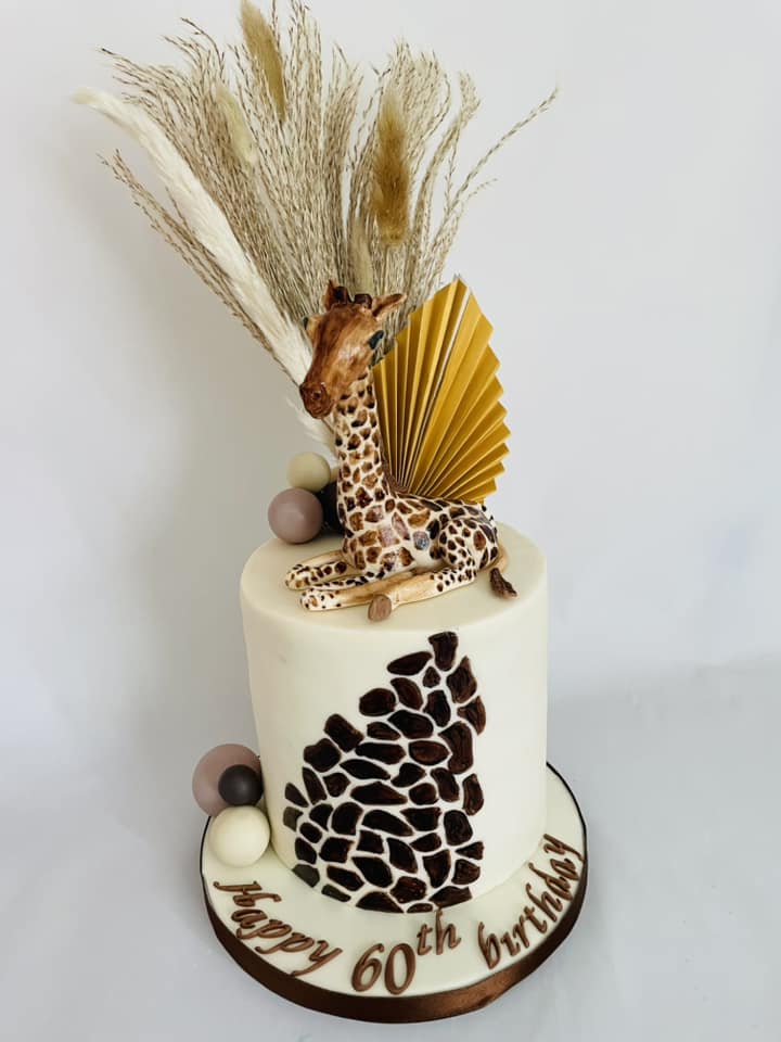 giraffe cake custom made with a fondant giraffe on top 