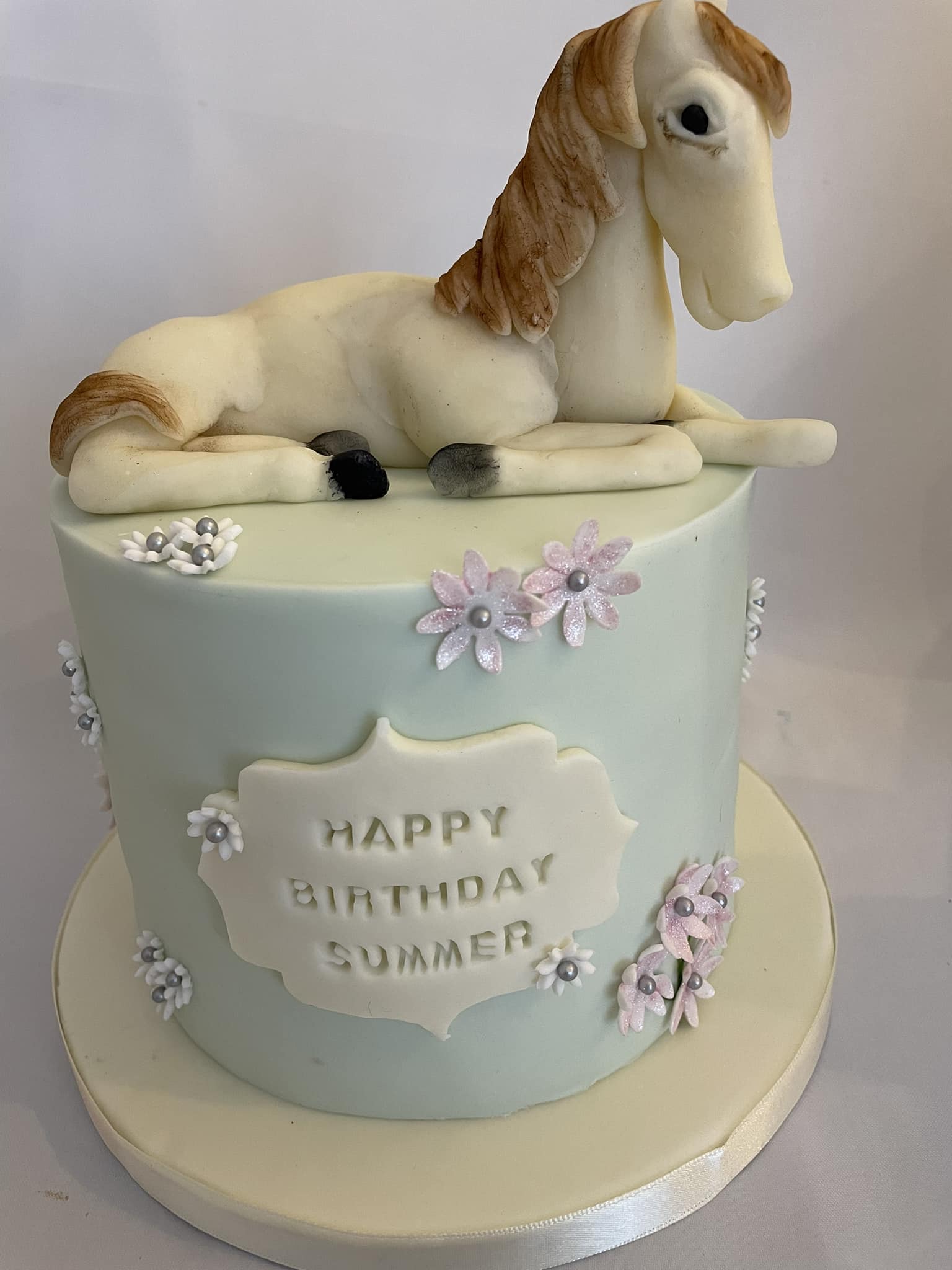 unicorn cake with sculpture of a unicorn on top 